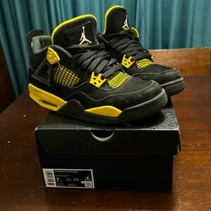 Yellow and black air jordan 4 retro. Also know as yellow thunders.